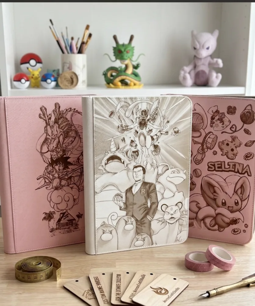 Three custom engraved binders displayed with collectible figures